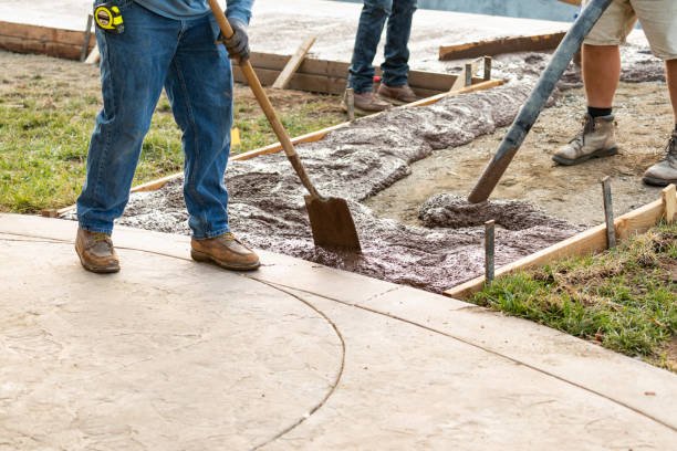 Construction Worker Pouring Wet Deck Cement Into Wooden Frame