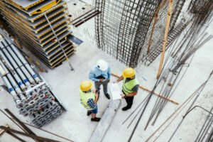 Best concrete contractors in Dallas, GA—a group of construction workers engaged in tasks on a busy site with equipment and building materials.