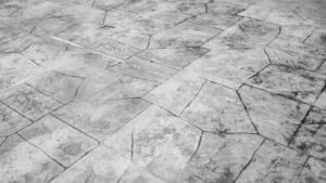 A concrete floor designed with a rock pattern, showcasing a stamped concrete patio for an elegant outdoor space. 