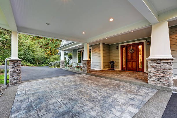 A beautiful home featuring a large front porch with elegant stamped concrete flooring.