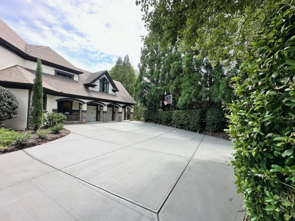 Image is showing a driveway of a home after concrete services have completed their work.